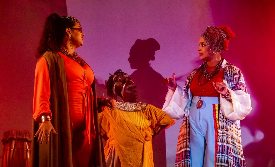 Elenco da ópera em cena com iluminação colorida